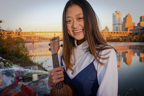Yunge Xiao, a sophomore statistics and sociology major, sits at Color Park with her ukelele on Nov. 6. 
