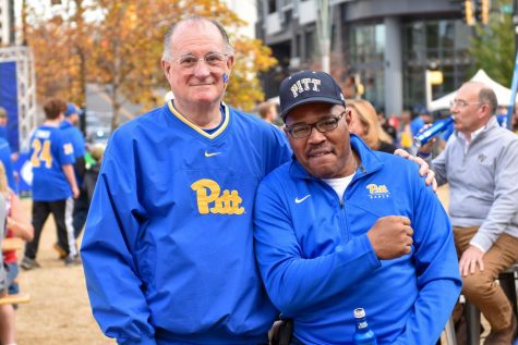 Pitt alumnus Tony Lupinetti (left) and former Pitt football player Troy Washington (right) pose at the ACC Fan Fest on Saturday afternoon.
