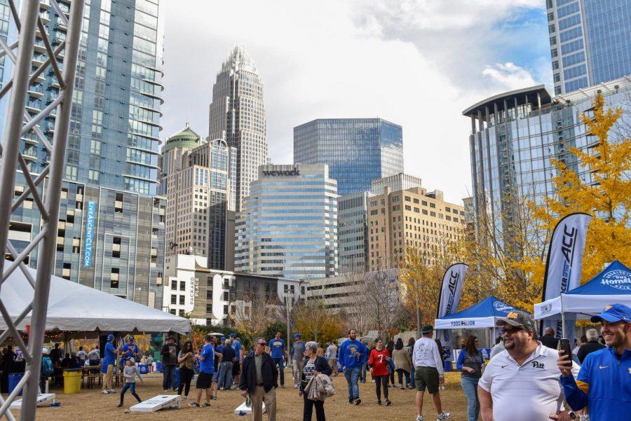 The skyline of Charlotte, North Carolina, looks over the ACC Fan Fest on Saturday afternoon.