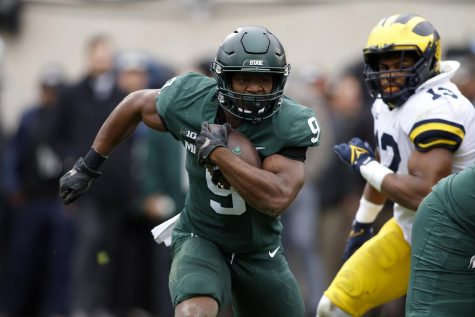Michigan States Kenneth Walker III (9) runs with the ball during the first quarter of a game against University of Michigan at Michigan State’s Spartan Stadium in East Lansing, Michigan. on Oct. 30.