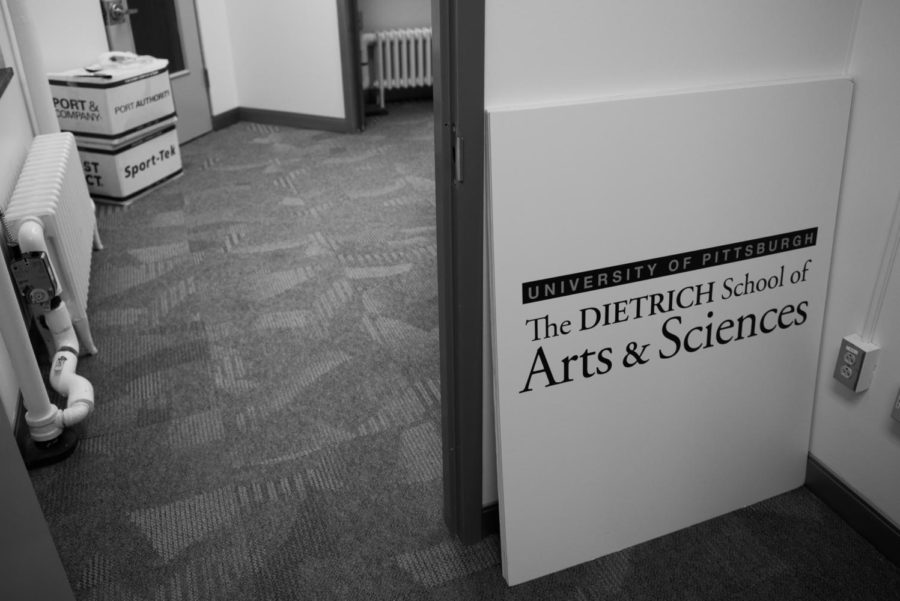 A Dietrich School of Arts and Sciences sign sits in the Cathedral of Learning in 2017.