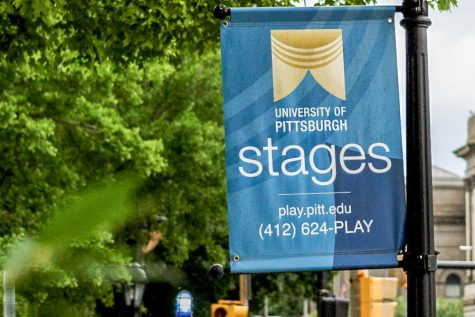 A Pitt Stages sign on Forbes Avenue. 
