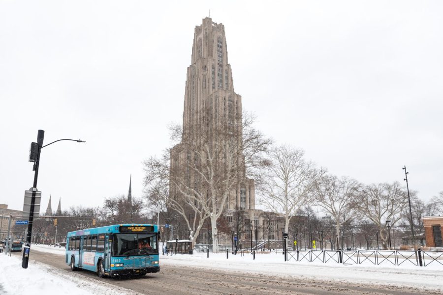 A Port Authority bus drives down a snowy Fifth Avenue on Monday afternoon.