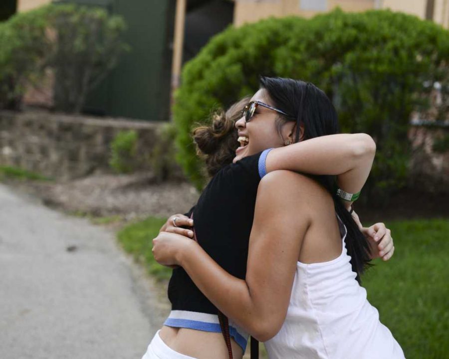 Two friends embrace outside of Bouquet Gardens in 2016.