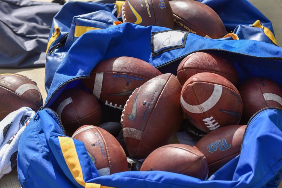 A bag of Pitt footballs at a Pitt football game.