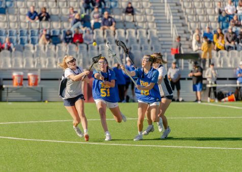 Pitt lacrosse players Dylana Williams (51) and Talia Zuco (19) fight for the ball during the team’s September playday against Duquesne at Highmark Stadium.