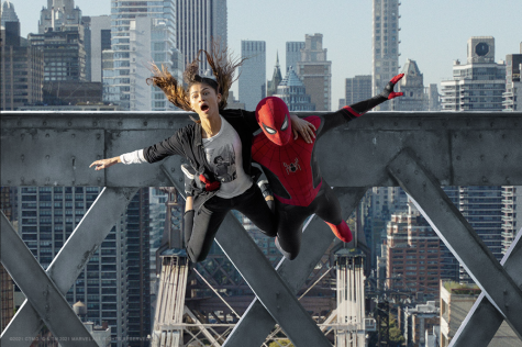Zendaya, left, playing Michelle “MJ” Jones, jumps with Tom Holland, right, playing Spider-Man in “Spider-Man: No Way Home.”