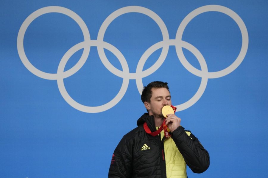 German olympian Johannes Ludwig kisses the gold medal he won for the luge mens single at the 2022 Winter Olympics on Sunday in Beijing, China.