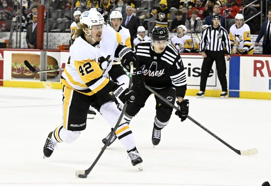 Pittsburgh Penguins right wing Kasperi Kapanen (42), left, and New Jersey Devils center Yegor Sharangovich (17) during a game on Sunday, Feb. 13 in Newark, New Jersey.
