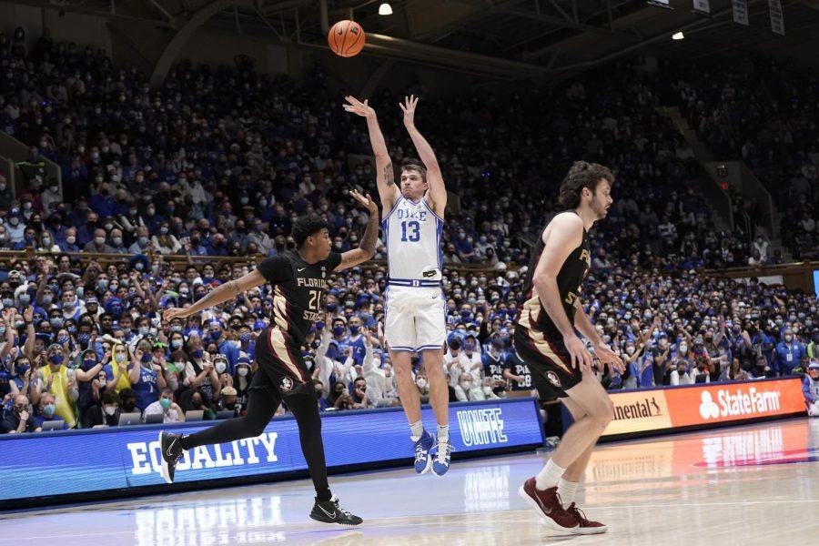Duke forward Joey Baker (13) shoots against Florida State guard CamRon Fletcher (21) during a game on Saturday in Durham, North Carolina.
