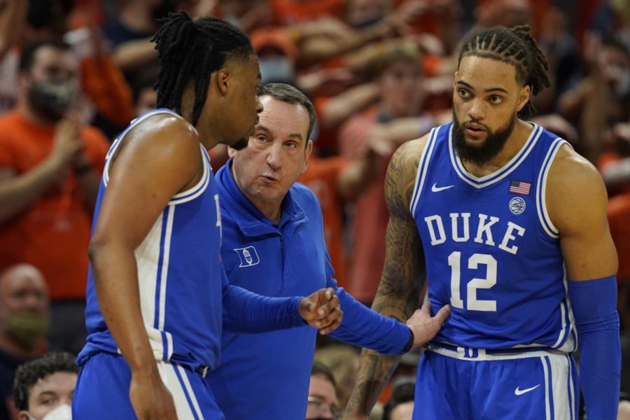 Duke head coach Mike Krzyzewski, center, talks with guard Trevor Keels (1), left, and Theo John (12) during a game against the University of Virginia on Wednesday in Charlottesville, Virginia.
