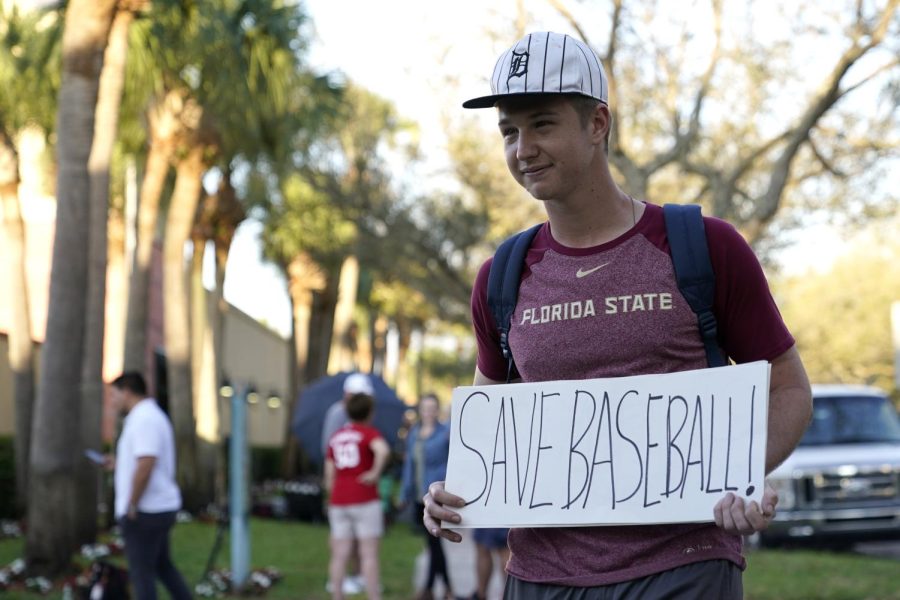 Baseball fan Noah McMurrain stands outside of the Roger Dean Stadium in Jupiter, Florida, on Monday.  
