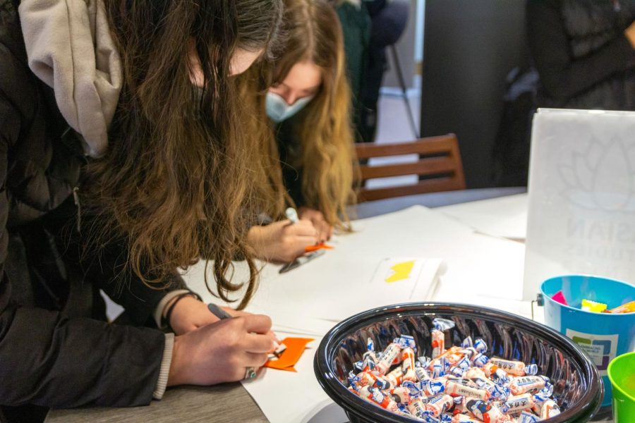 Pitt students make origami tiger crafts at a Lunar New Year celebration hosted in Posvar’s Global Hub on Wednesday. 