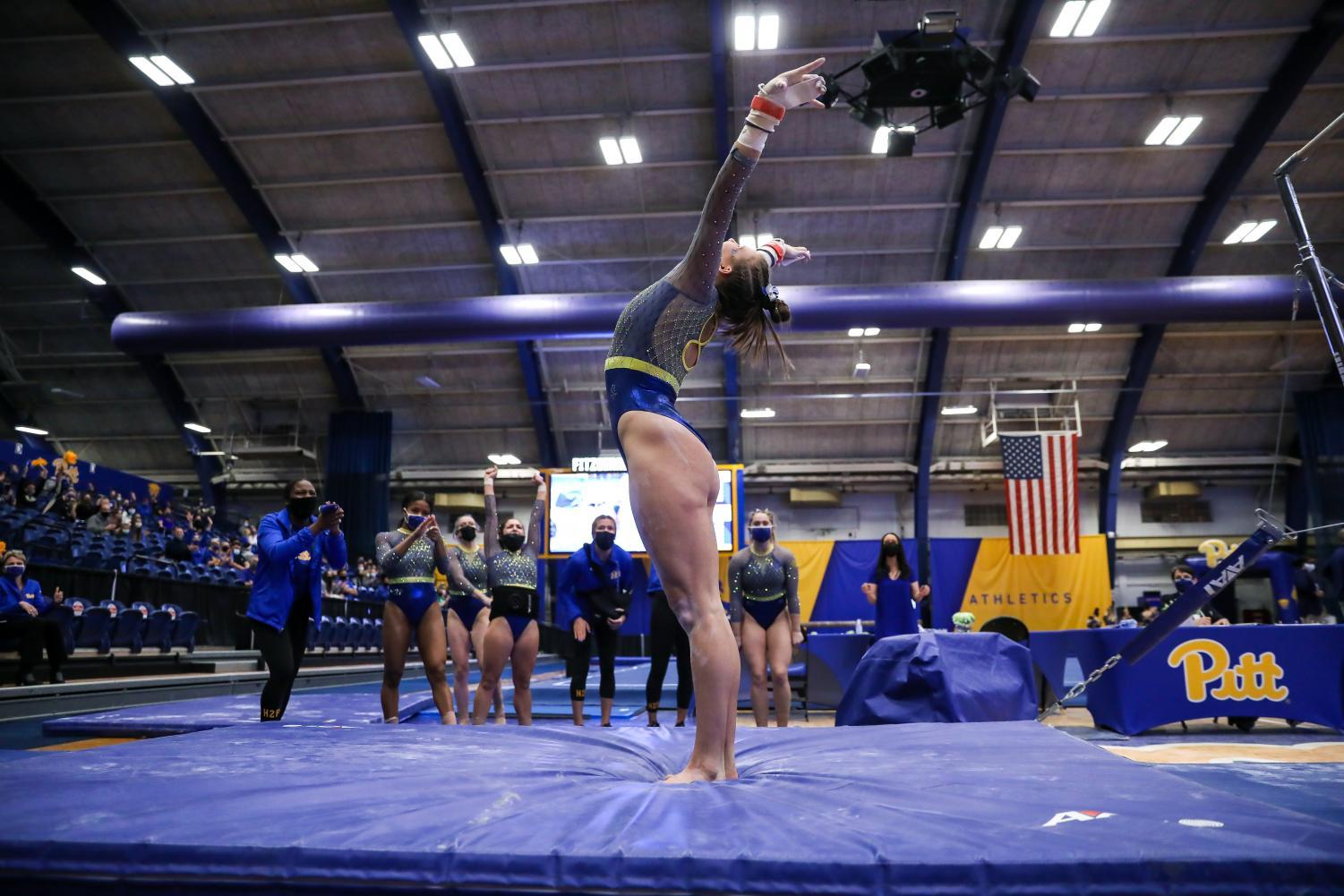 A Pitt gymnast lands in the Fitzgerald Field House. 
