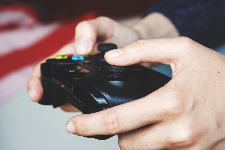 A player holds an Xbox controller. 