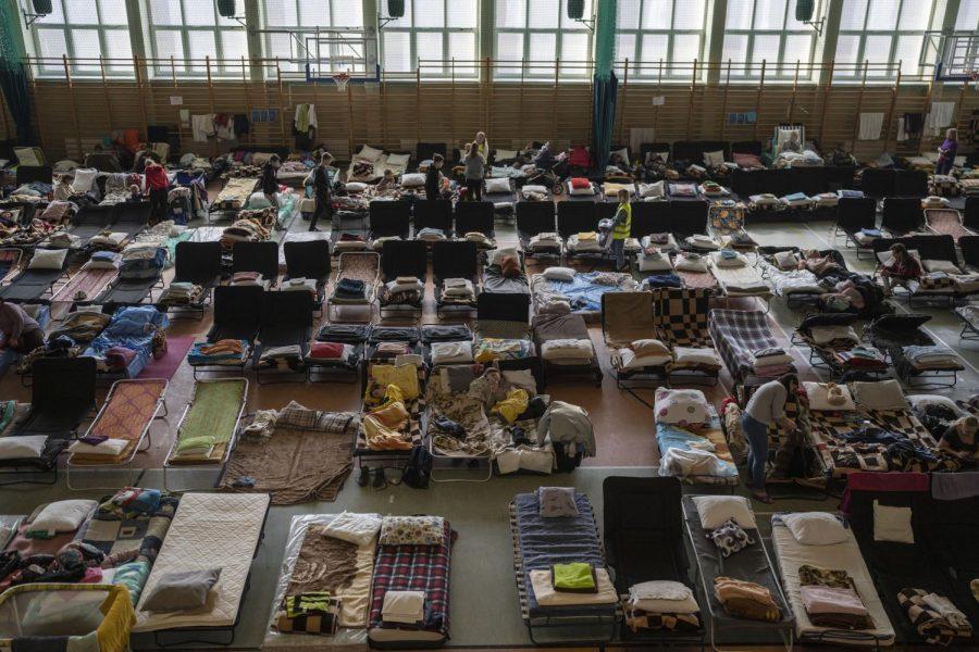 People who fled the war in Ukraine rest inside an indoor sports stadium being used as a refugee center, in the village of Medyka, a border crossing between Poland and Ukraine, on Tuesday.
