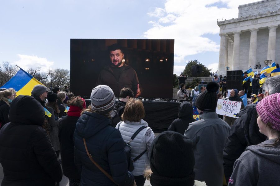 Supporters of Ukraine watch a pre-recorded video by the president of Ukraine, Volodymyr Zelenskyy, during a Stand with Ukraine rally at the Lincoln Memorial in Washington, D.C., on Sunday. 
