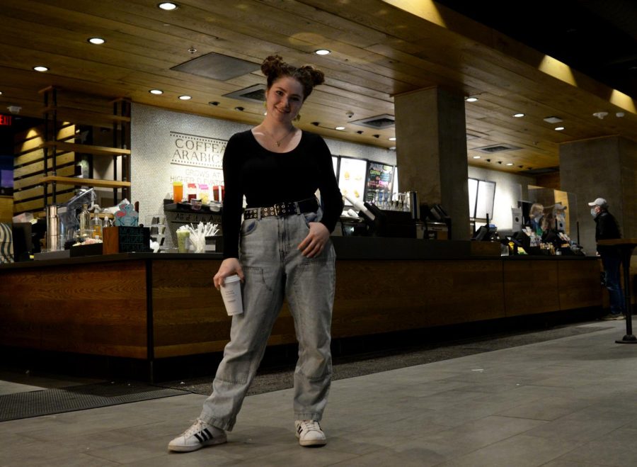 Abby Batkhan, a barista and Pitt student, stands with a cup of coffee in the Amos Starbucks.