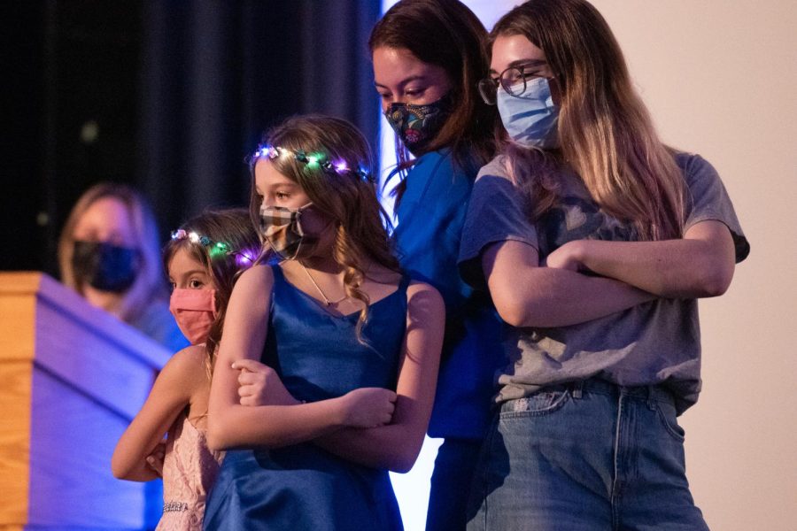 Two Pitt Dance Marathon miracle kids and two Pitt students on stage at the Pitt Dance Marathon’s Fashion Show Wednesday night.
