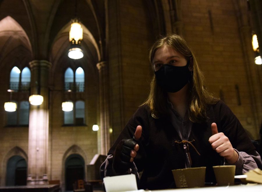 Maighread Southard-Wray, the vice president of Pagans at Pitt, gives two thumbs up to a club member during their Ostara celebration to commemorate the Spring equinox in the Cathedral of Learning last Sunday. 
