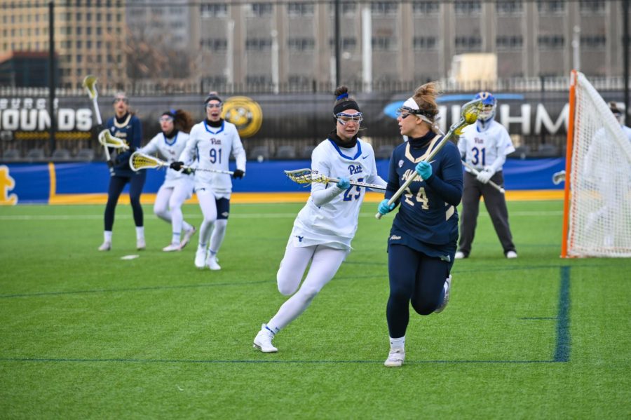 Pitt+defense+Brittney+Villhauer+%2825%29+battles+for+the+ball+with+an+Akron+women%E2%80%99s+lacrosse+player+Monday+night.