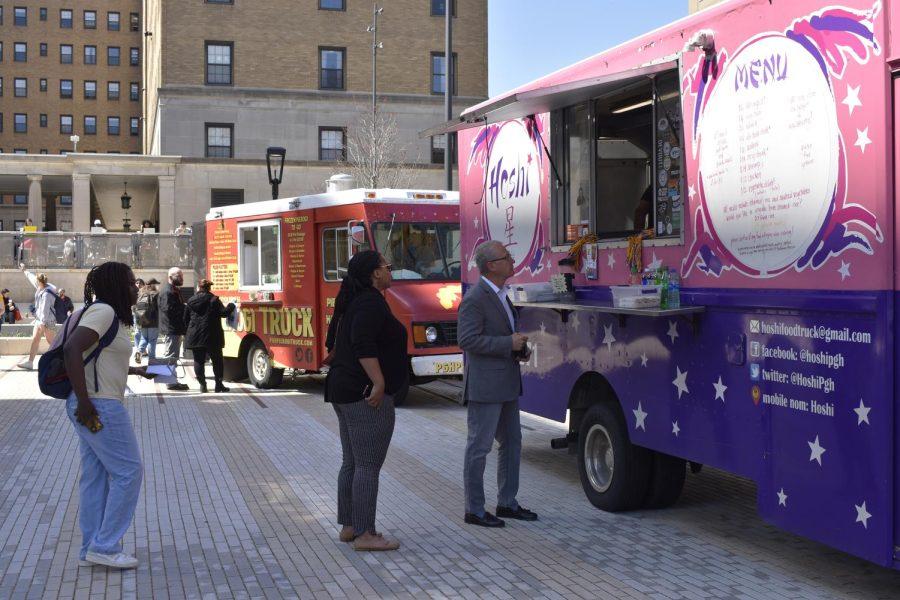Patrons wait in line to order from the Hoshi food truck at Thursday’s Food Truck Roundup outside of the William Pitt Union. 