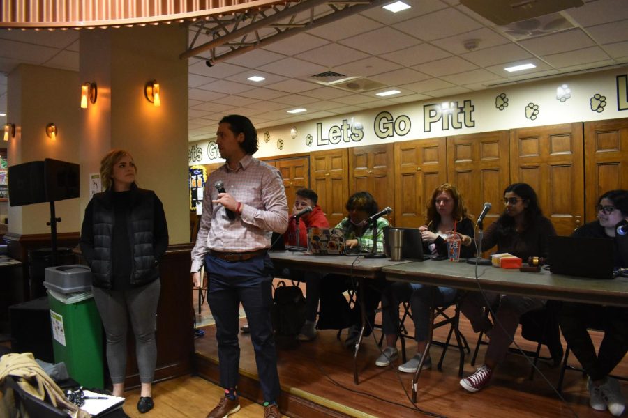 Kathryn Lavelle (left) and Steve Schurr, representatives from Pitt Eats, speak at Student Government Board’s weekly meeting in Nordys Place on Tuesday night.