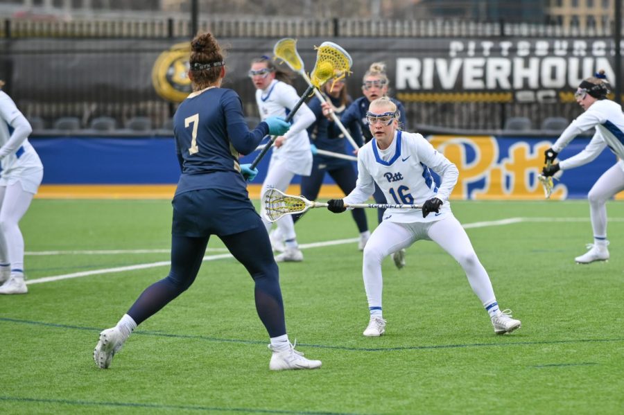 Senior midfielder Peyton Reed (16) faces off a player from Akron during a Pitt women’s lacrosse game in March.