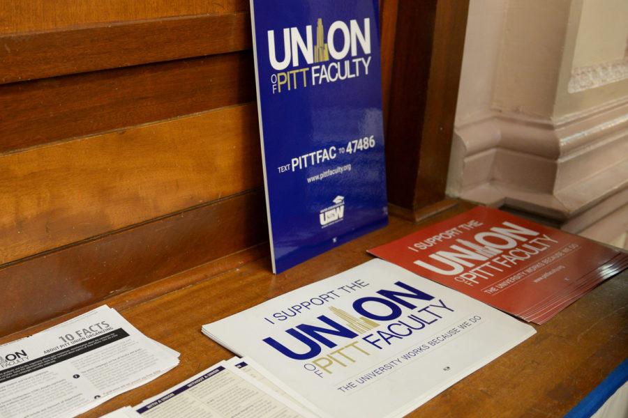 Pitt Faculty Union flyers on campus table. 