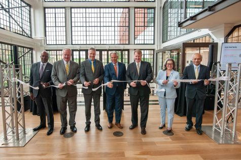 From left, Tim Sanders, John Grady, Chancellor Patrick Gallagher, Thomas Osha, Rich Fitzgerald, Deb Gross and Anantha Shekhar participate in ribbon cutting ceremony on Thursday to celebrate the opening of The Assembly. 