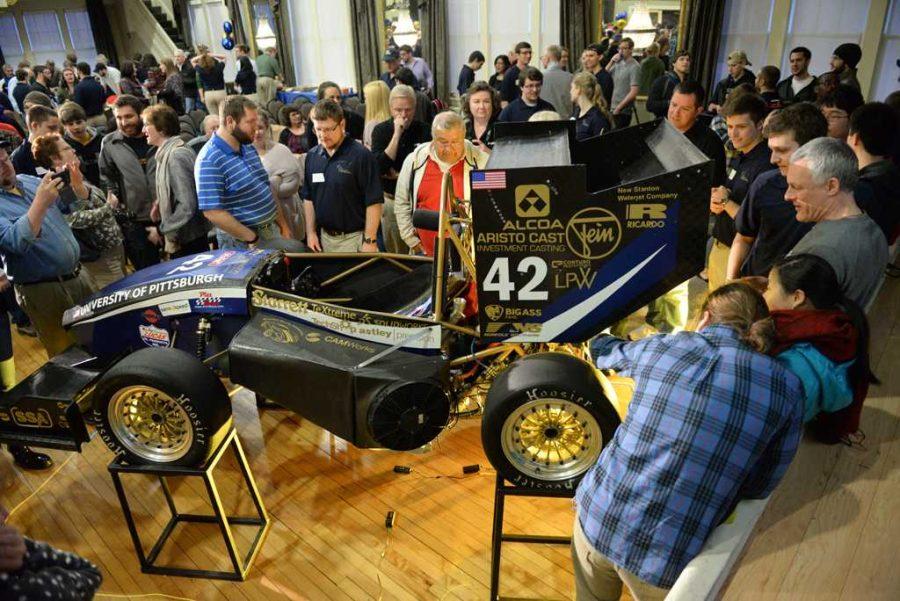 Attendees look at the PR-028 at a formula SAE showcase in 2016. 