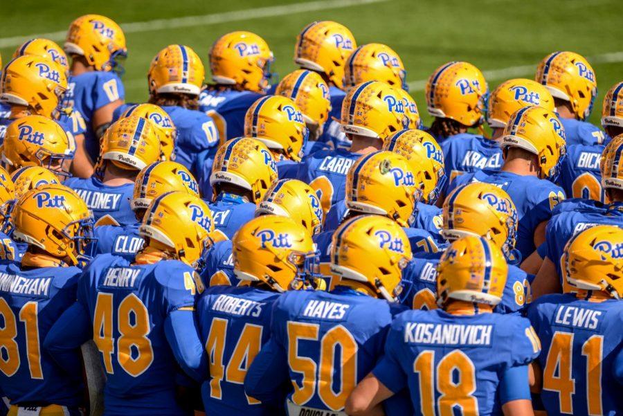 Pitt football players at the start of a game at Acrisure Stadium.