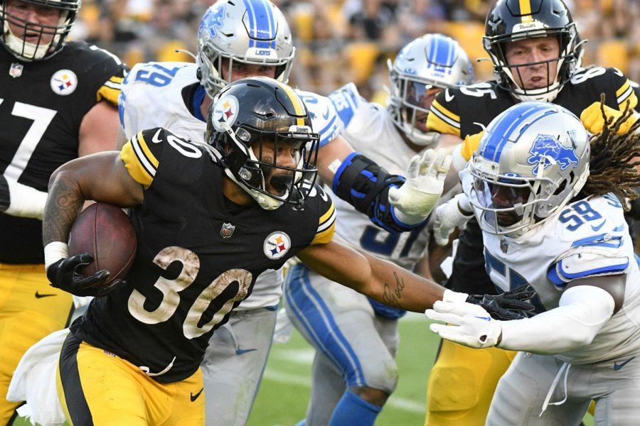 Pittsburgh Steelers running back Jaylen Warren (30) tries to get past Detroit Lions linebacker James Houston (59) during a preseason football game on Aug. 28 in Pittsburgh. 
