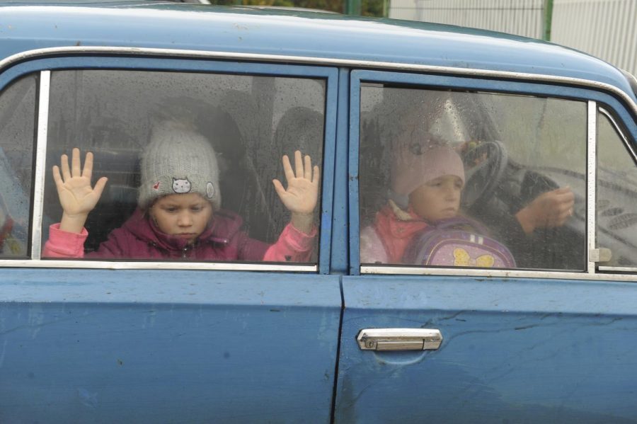 Children look through car windows as they and other refugees from the Kharkov Region of Ukraine arrive at a temporary camp in Belgorod, Russia, on Wednesday. Thousands fled northeastern Ukraine to Russia amid the Ukrainian counteroffensive in the region. 
