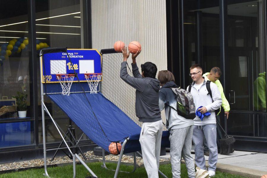 Attendees play a basketball game at a celebration outside of Benedum Hall to commemorate the construction of the Campus Recreation and Wellness Center. 
