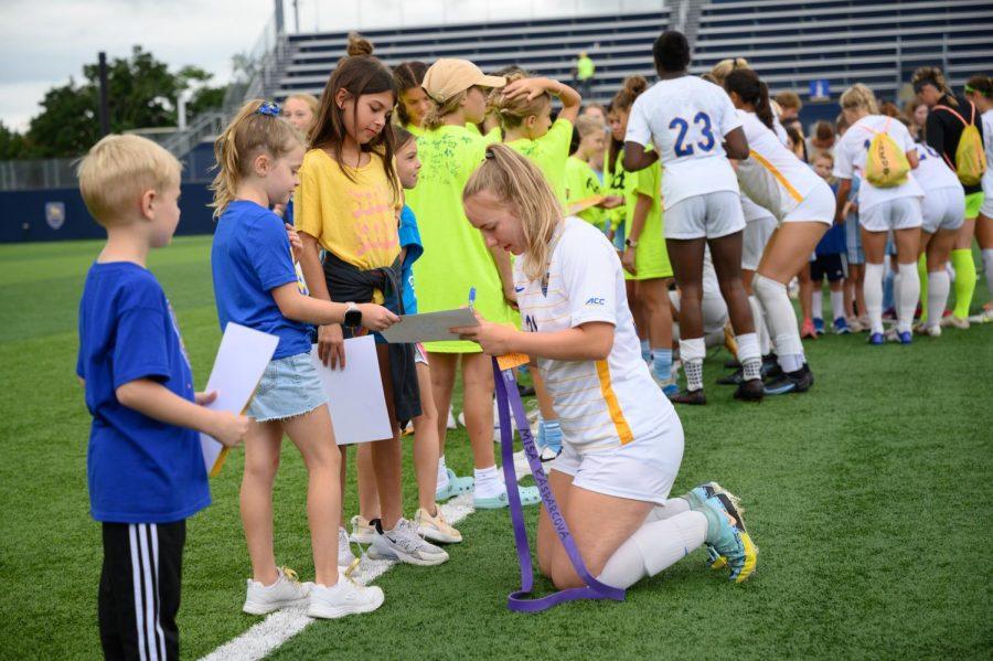 Pitt first year midfielder Misa Kasparcova (31) signs autographs after Sunday’s game against West Liberty University at Ambrose Urbanic Field. 
