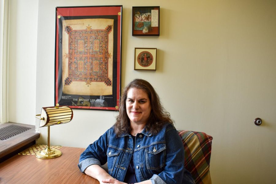 Pitt English professor Shannon Reed sits in her office.