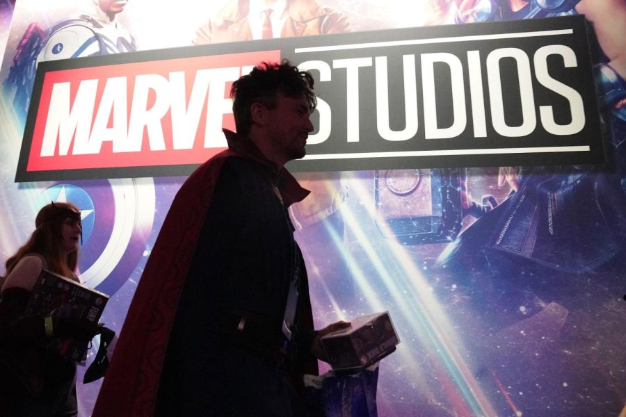 A cosplayer dressed as Doctor Strange passes by a Marvel Studios exhibit at the D23 Expo Saturday, Sept. 10 in Anaheim, Calif. 