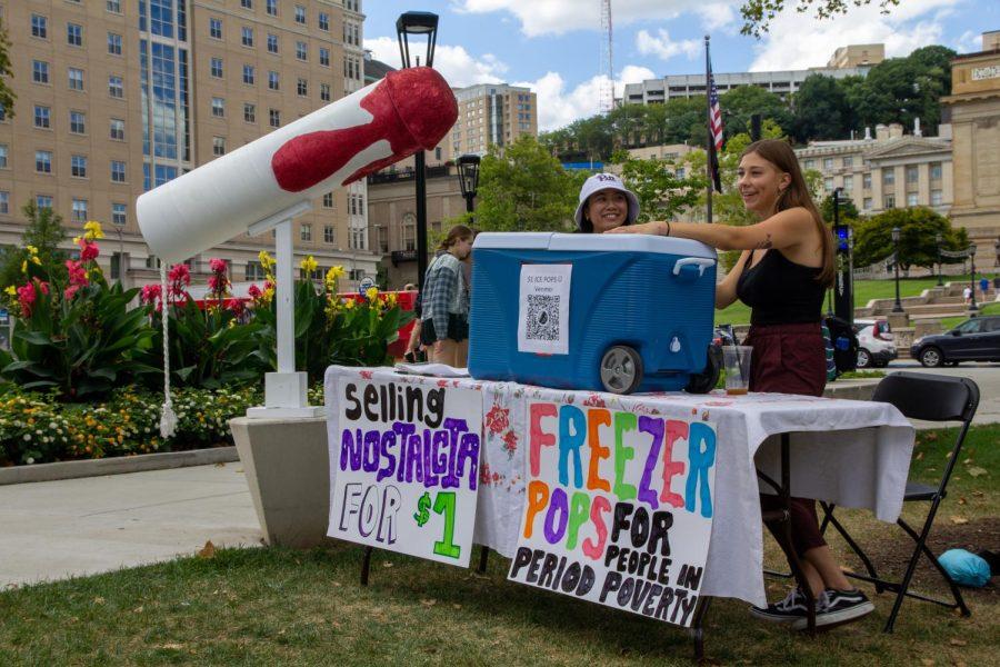 Pitt+students+selling+%E2%80%9Cfreezer+pops+for+people+in+period+poverty%2C%E2%80%9D+according+to+a+sign+on+their+booth%2C+at+the+Pitt+Arts+Fest+on+the+WPU+lawn+on+Friday.+%0A