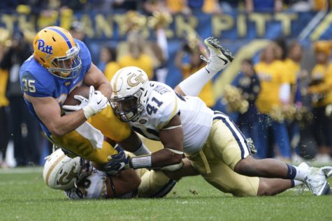 Fullback George Aston (35) is tackled in a Pitt football game against Georgia Tech in 2016.