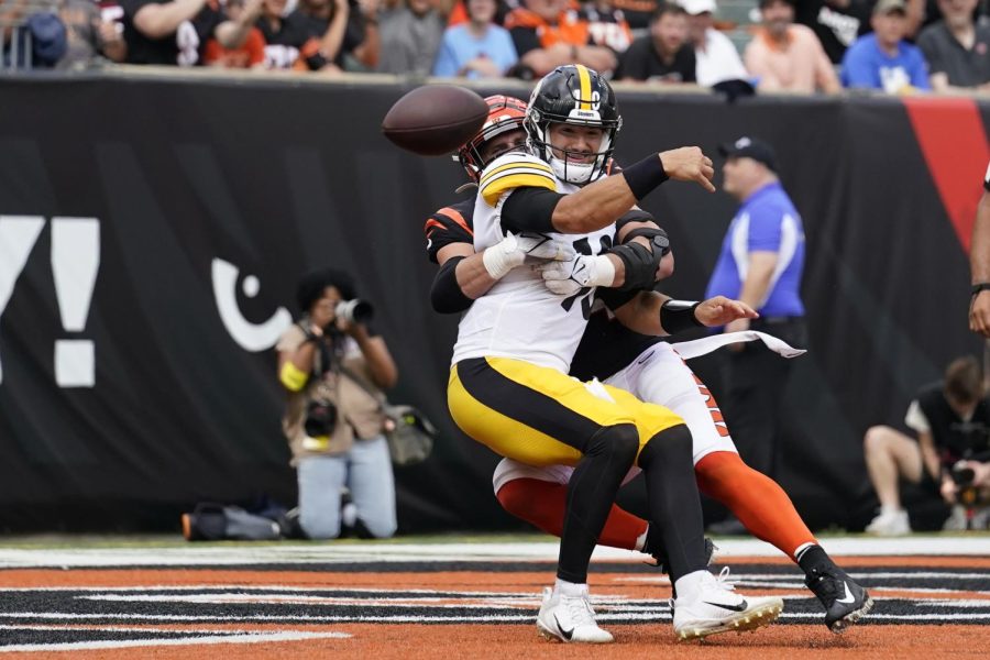 Pittsburgh Steelers quarterback Mitch Trubisky (10), front, is pressured by Cincinnati Bengals defensive end Sam Hubbard, back, as he throws during the second half of an NFL football game on Sunday, Sept. 11, 2022, in Cincinnati. 