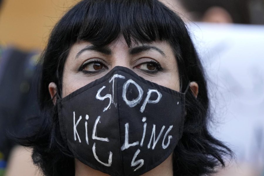 An activist wears a message on her protective face mask that reads Stop Killing Us during a protest against the death of Iranian Mahsa Amini in Lebanon on Sunday. 