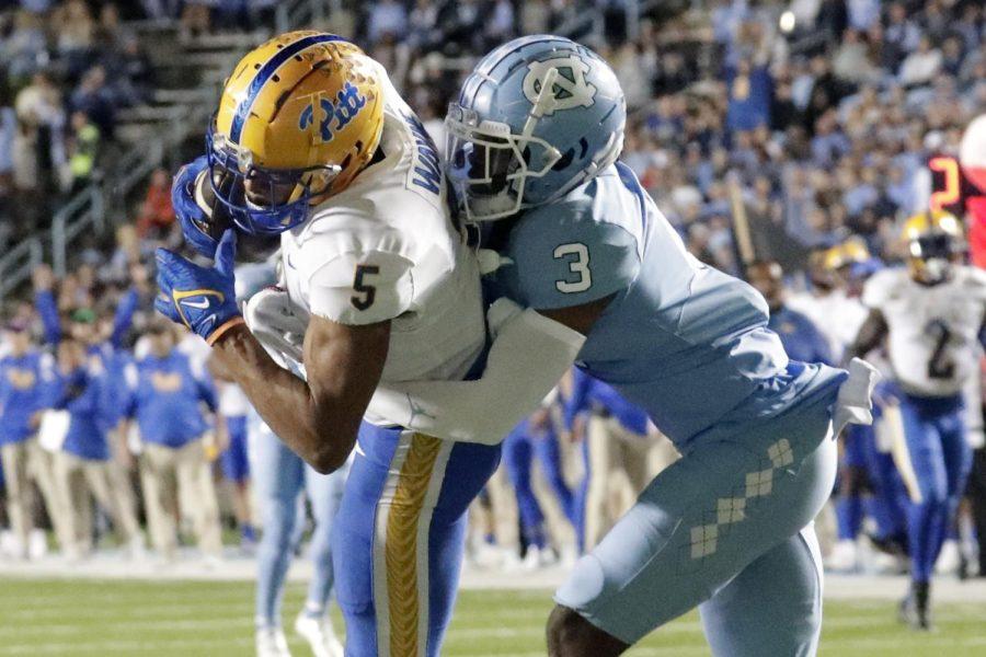 Pittsburgh wide receiver Jared Wayne (5), left, hauls in a long pass against North Carolina defensive back Storm Duck (3) to set up a touchdown during Saturday’s game in Chapel Hill, North Carolina. 

