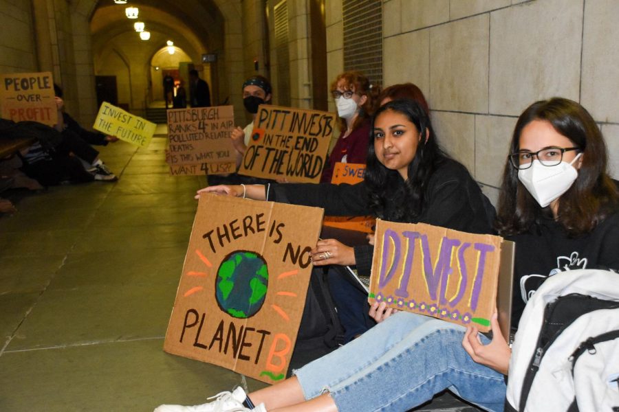Members of the Fossil Free Pitt Coalition protest outside of the Chancellor’s office Friday afternoon.