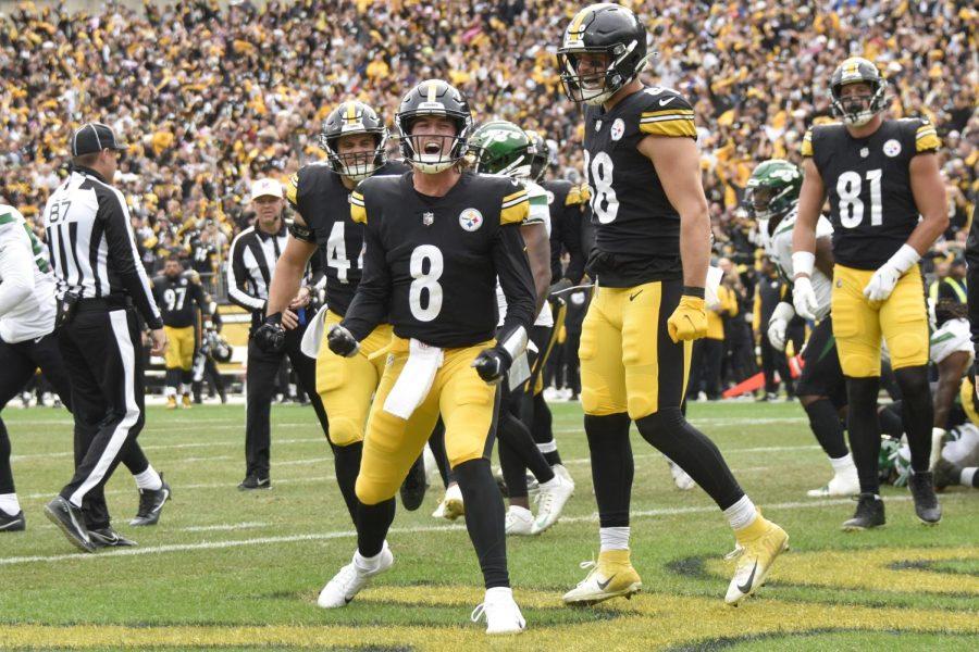 Pittsburgh Steelers quarterback Kenny Pickett (8) celebrates beside teammates after scoring a touchdown against the New York Jets on Oct. 2 at Acrisure Stadium.
