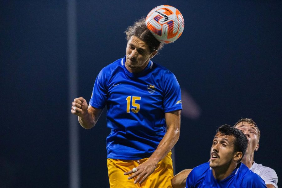 Graduate midfielder Ideal Shefqeti (15) bounces the ball off of his head during the Pitt mens soccer game vs. Akron in September. 