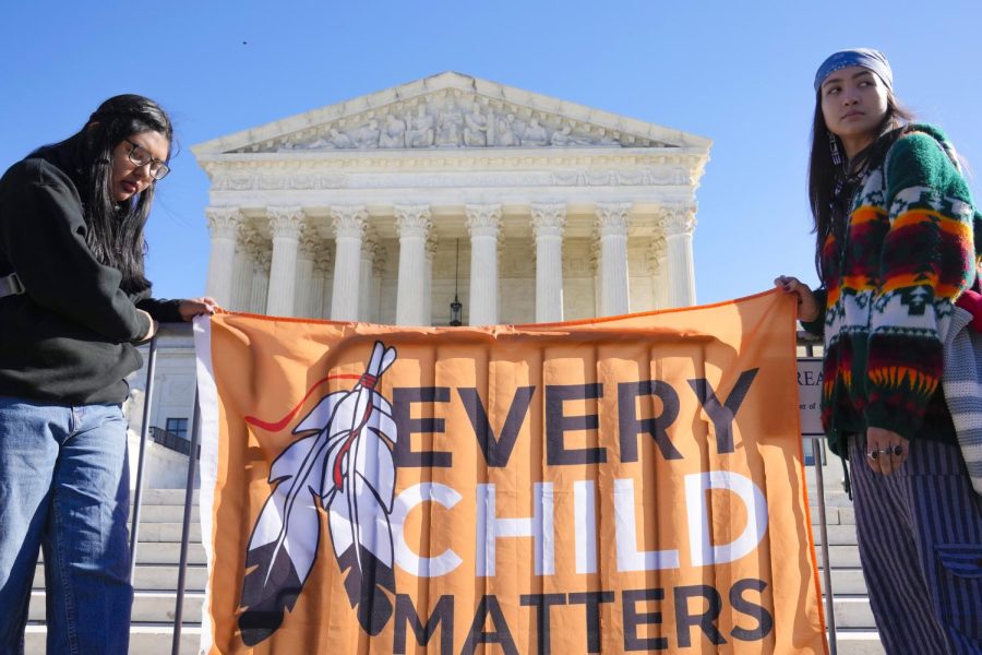 Demonstrators stand outside of the U.S. Supreme Court, as the court hears arguments over the Indian Child Welfare Act last Wednesday in Washington. 

