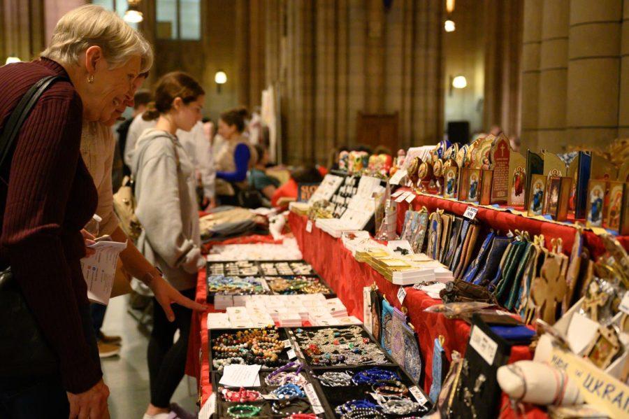 Attendants look at objects for sale at the Slovak Festival in the Cathedral of Learning on Sunday.