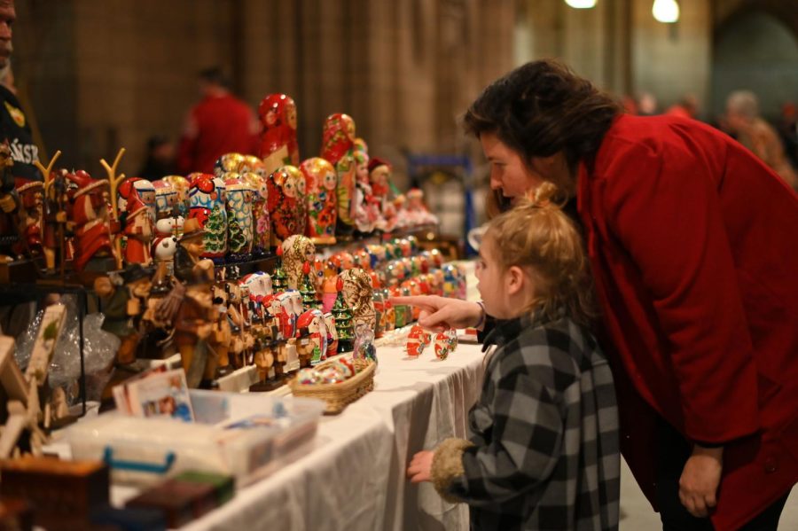 Attendees look at a table of matryoshka dolls and other trinkets on sale at Sunday’s Polish Festival in the Cathedral of Learning. 
