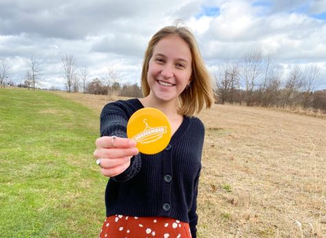 Zoe Frantz, a junior marketing major, holds a Dressember pin.